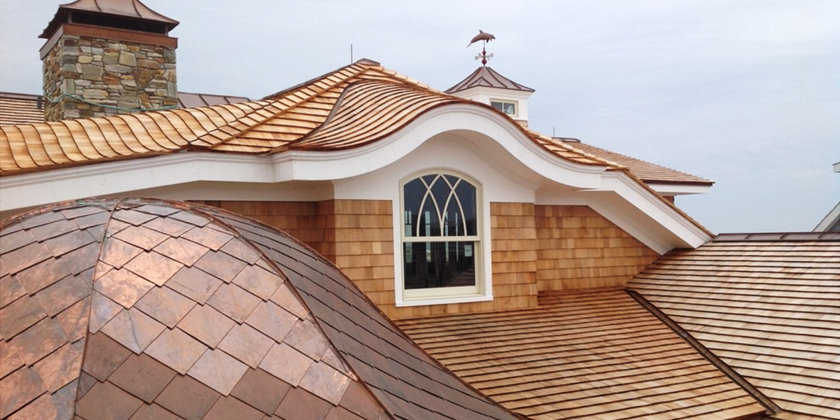 Curved roof assembly fabricated off-site and installed on a house